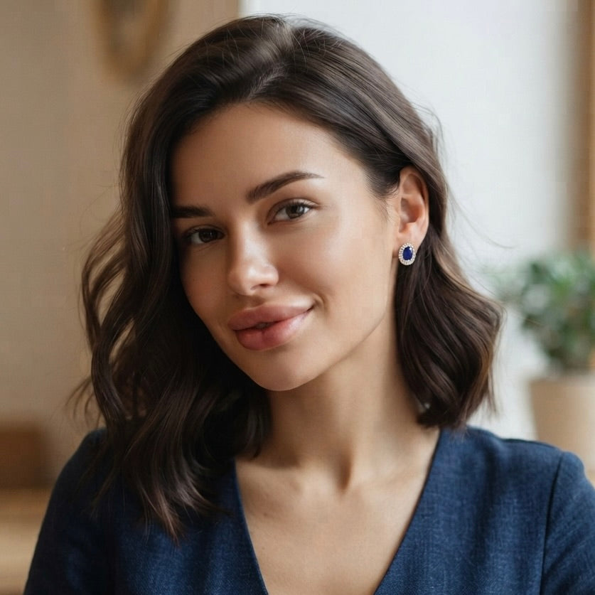 blue sapphire earring on the girls earlobe 