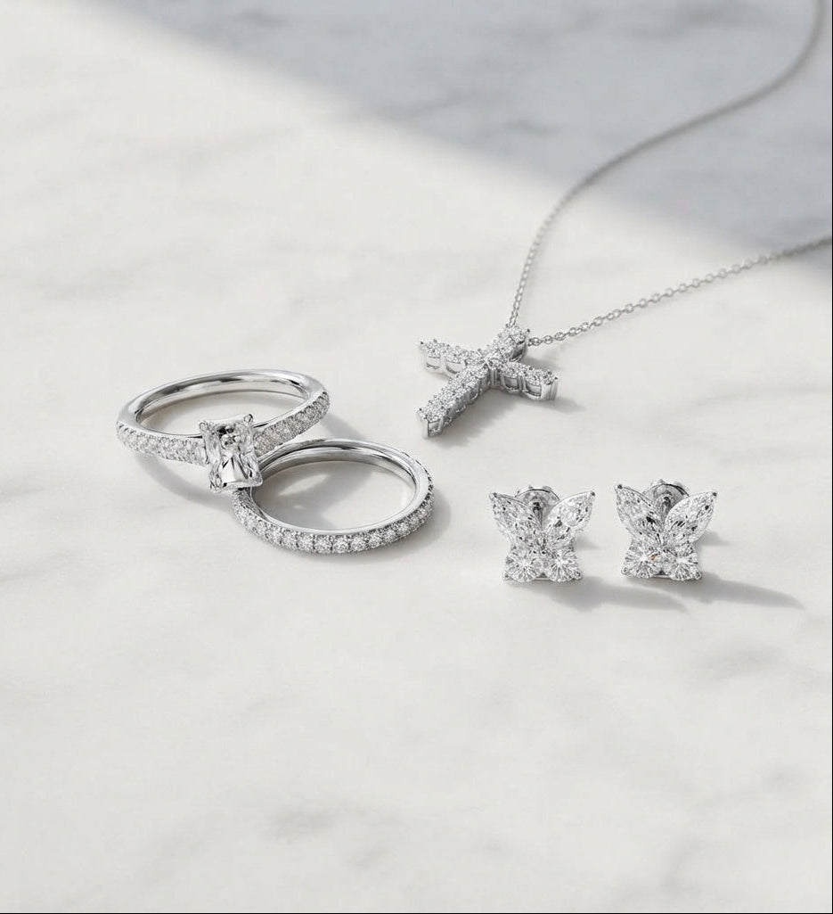 Lab grown diamond jewelry collection with gold rings, cross necklace and diamond earrings