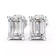 A pair of emerald-cut diamond stud earrings in white gold setting, shown against a plain white background.