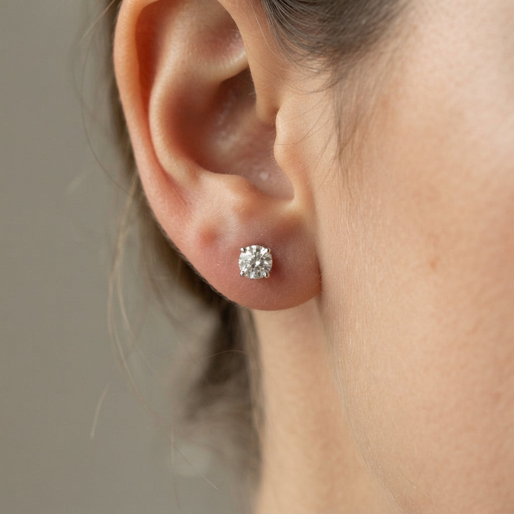 Diamond stud earrings on a girl earlobe 