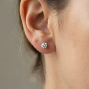 Diamond stud earrings on a girl earlobe 