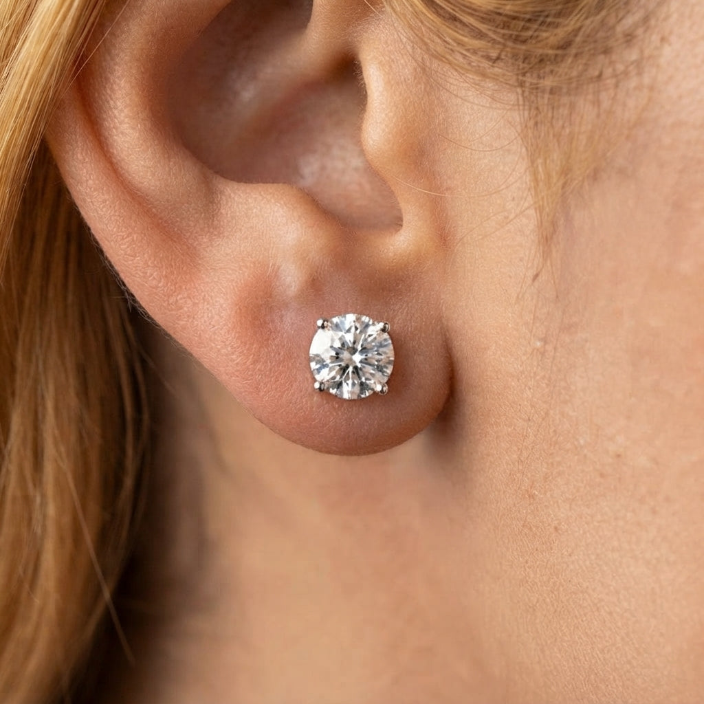 classic diamond stud earrings on a girl earlobe