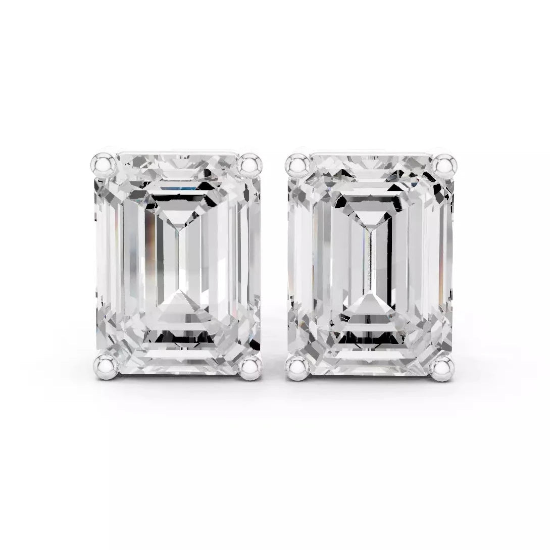 Emerald cut diamond stud earrings on a white background