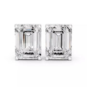 Emerald cut diamond stud earrings on a white background