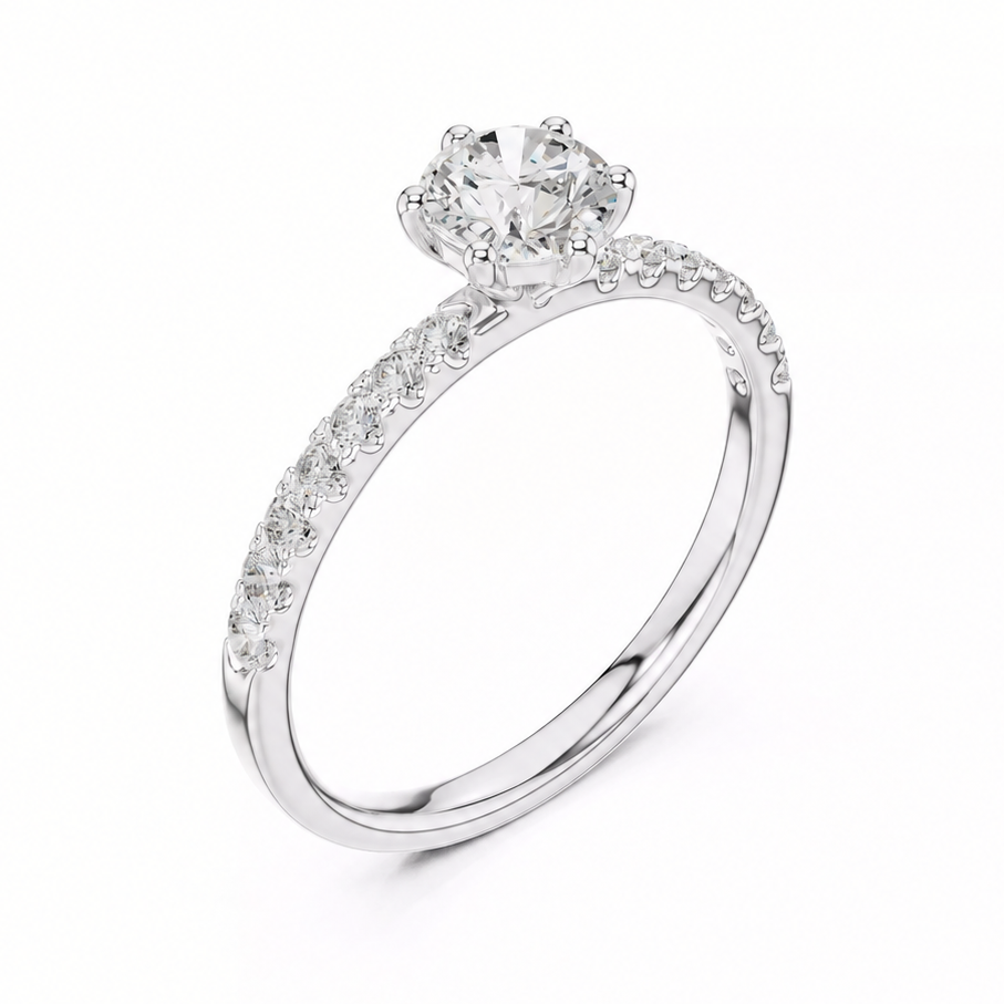 A white gold solitaire engagement ring with a round-cut center stone and a pavé-set band, shown on a clean white background.