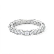 White gold diamond eternity ring with a full circle of round-cut diamonds set in a polished gold band, shown on a plain white background.