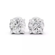 A pair of round-cut stud earrings in 14k white gold four-prong setting, shown on a clean white background.