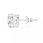 A single gold stud earring with a clear round gemstone in a 4 prong setting, shown from a side profile view on a white background.