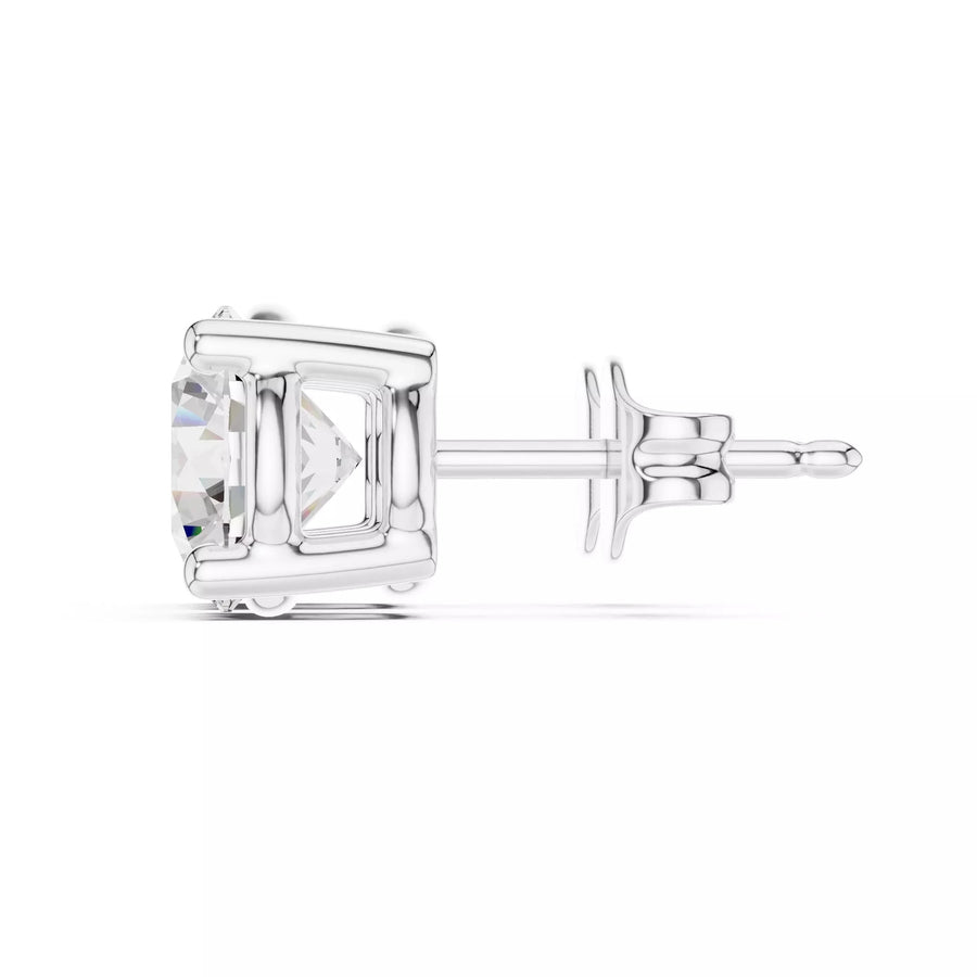 A single gold stud earring with a clear round gemstone in a 4 prong setting, shown from a side profile view on a white background.
