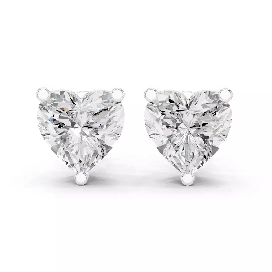 A pair of heart-shaped diamond stud earrings in white gold setting, photographed on a clean white background.