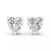 A pair of heart-shaped diamond stud earrings in white gold setting, photographed on a clean white background.