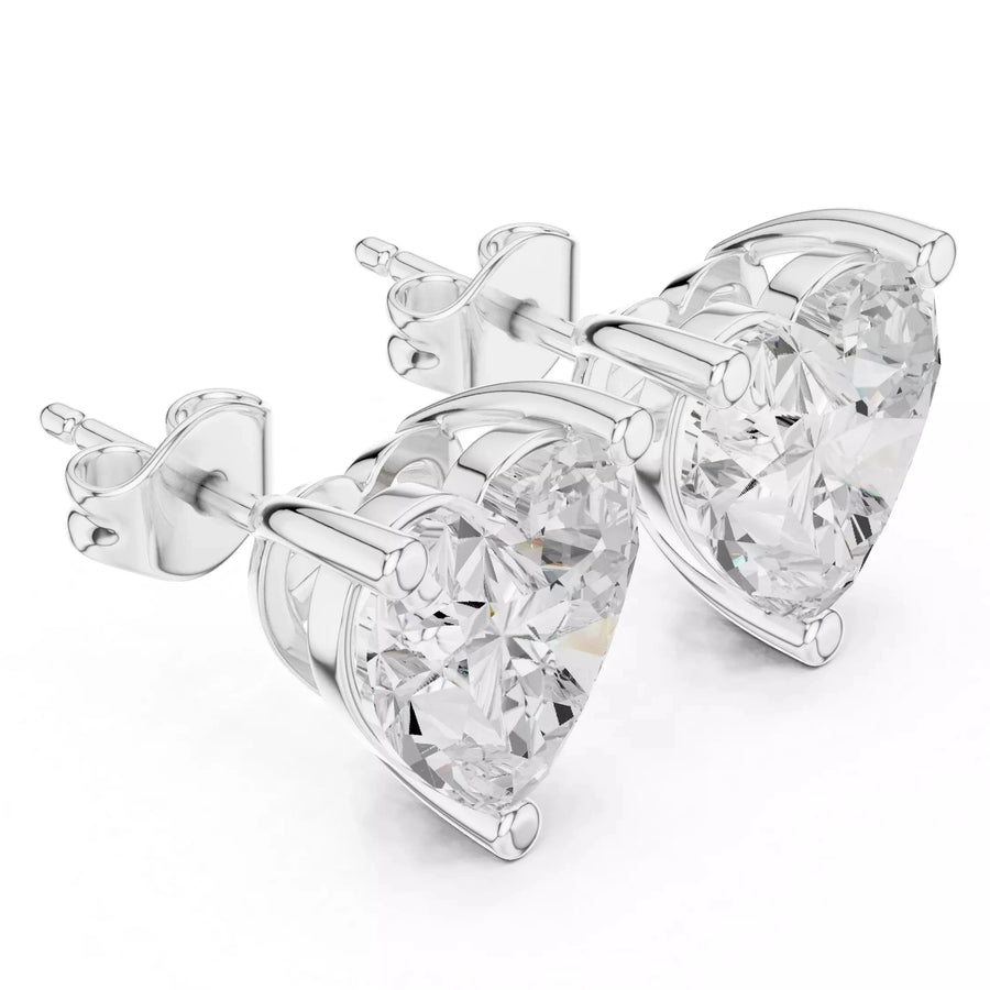 A pair of heart-shaped stud earrings featuring clear heart-cut gemstones in white gold setting, shown on a plain white background.