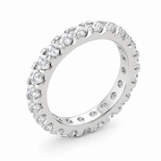 A white gold eternity ring set with round brilliant-cut diamonds, shown at an angle on a clean white background.